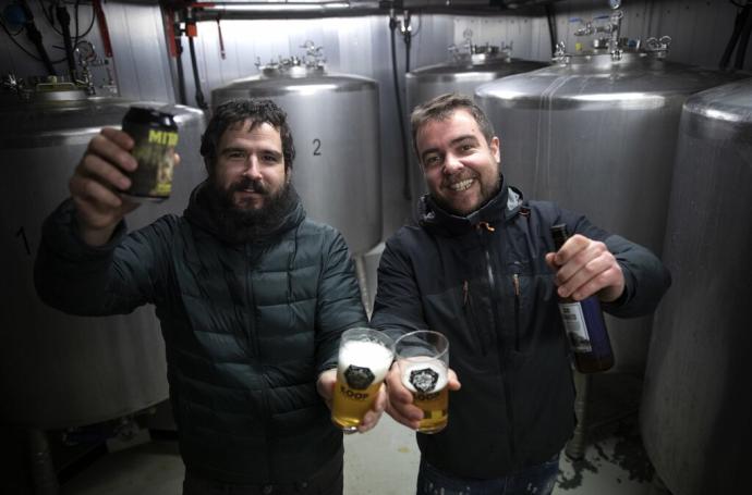 Jurdan Eguren y Aritz Aranguren, tan contentos con sus cervezas Mitika y San Donato junto a algunos de los tanques de fermentación de su cocina.