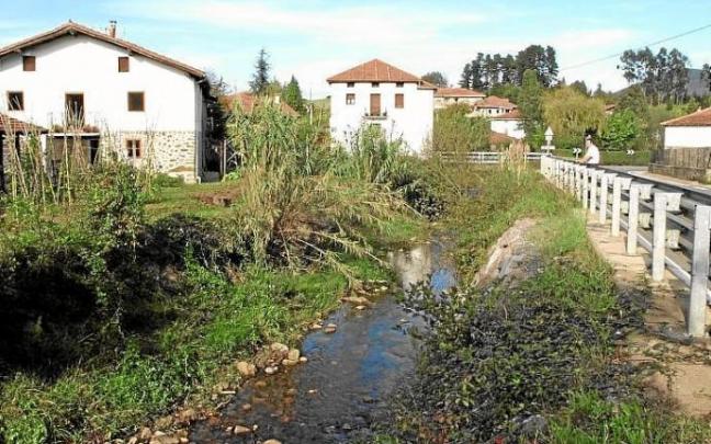 Una persona contempla el cauce del río Mape a su paso por Busturia. Una persona contempla el cauce del río Mape a su paso por Busturia.