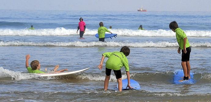 Chavales en un cursillo de surf en la playa de la Zurriola.