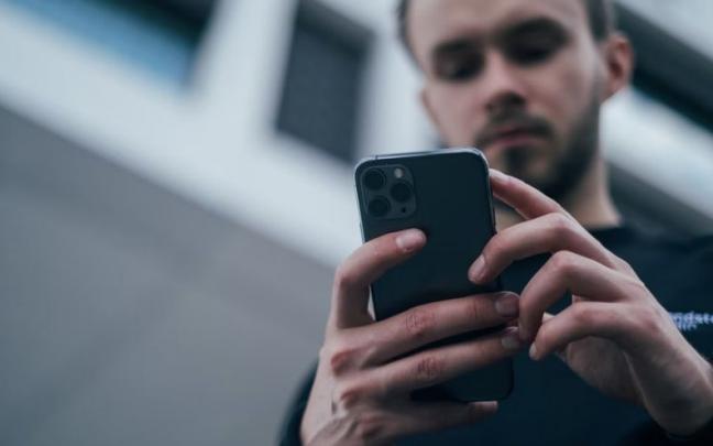 Una persona usando un teléfono móvil. Una persona usando un teléfono móvil.