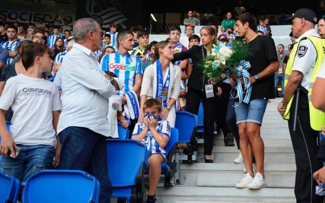 Mikel Oyarzabal se dispone a entregar un ramo de flores a los familiares de Txomin Landa.
