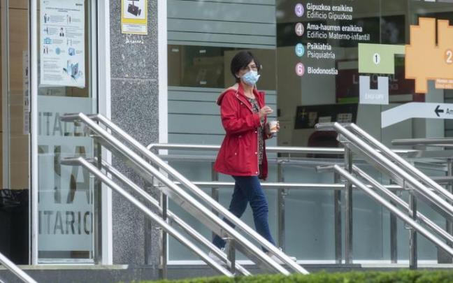 Una persona junto a la entrada del Hospital Universitario de Donostia.