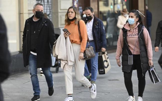 Varias personas caminan por la calle.