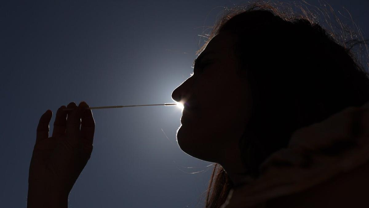 Una mujer se realiza un test de antígeno.