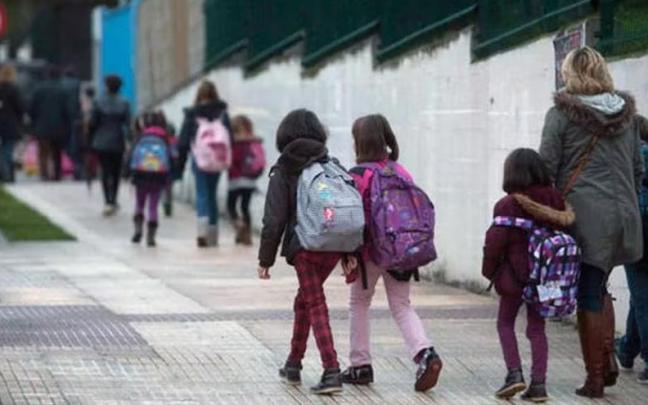 Un grupo de alumnos se dirigen a un colegio. Un grupo de alumnos se dirigen a un colegio.