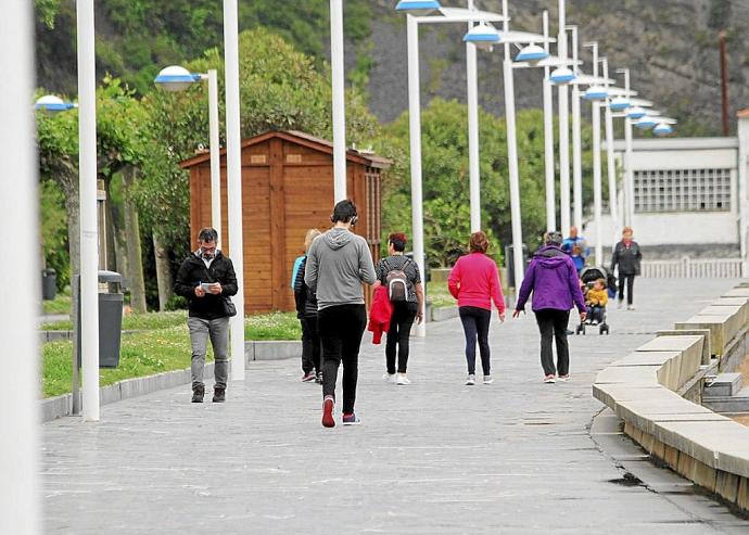 Varias personas caminan por el paseo de la playa, que se contempla remodelar en las cuentas del 2022.