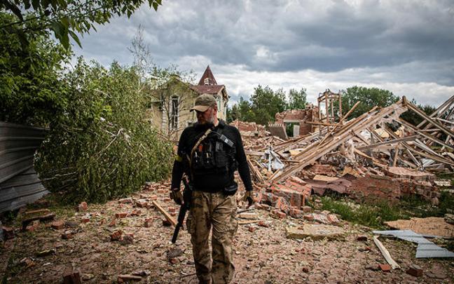 Un soldado ucraniano pasea ante los restos de una vivienda destruida en Donetsk.