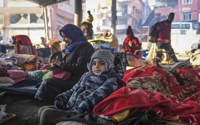 Un niño junto a su madre en unas instalaciones para acoger a las víctimas del terremoto en Turquía.
