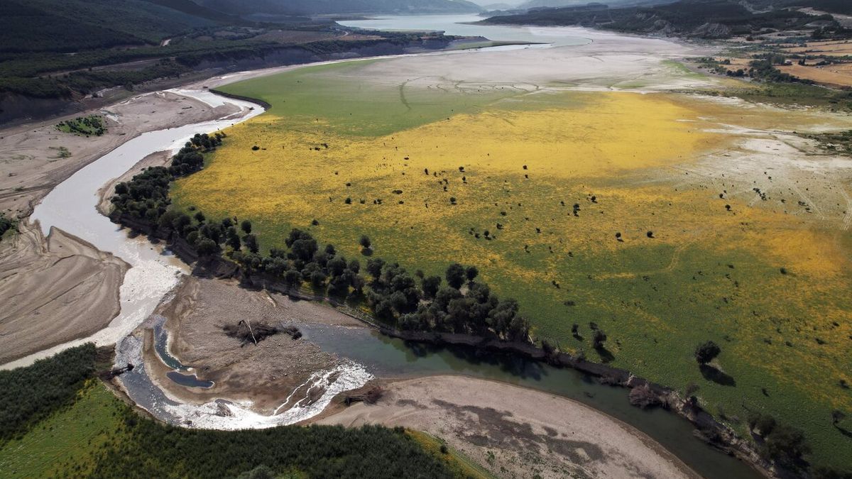 Imagen tomada con un dron de la cola del pantano de Yesa con el río Aragón prácticamente sin agua y donde se aprecia también el descenso de su capacidad.