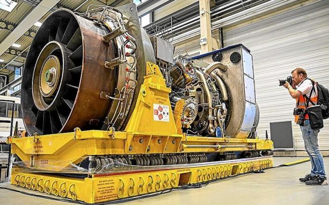 Un fotógrafo toma imágenes de la turbina, preparada para ser enviada a Rusia, en la planta de Siemens Energy en Muelheim. Foto Schuermann/Afp