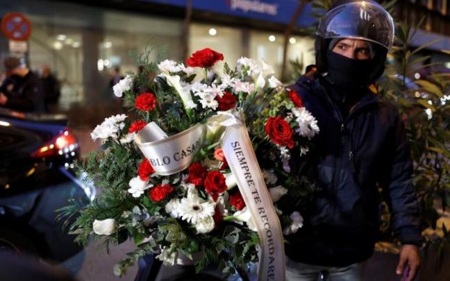 La corona de flores con el texto 'Pablo Casado, siempre te recordaremos' junto a la sede del PP en la calle Génova.