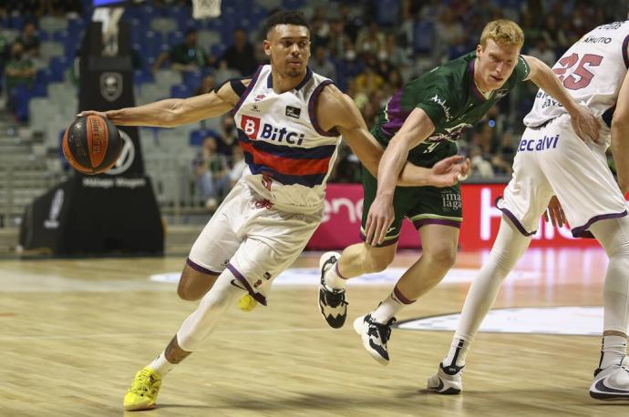 El jugador del Baskonia Wadfw Baldwin supera la defensa de Alberto Díaz (d), del Unicaja durante el partido de Liga Endesa que disputan en el Palacio de Deportes José María Martín Carpena.