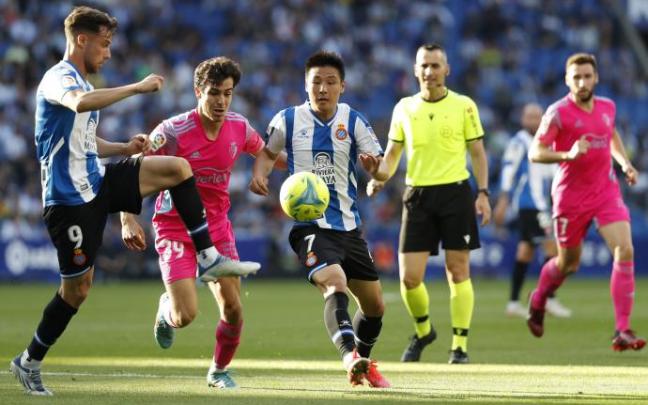 Wu Lei pelea por el balón con Manu Sánchez.