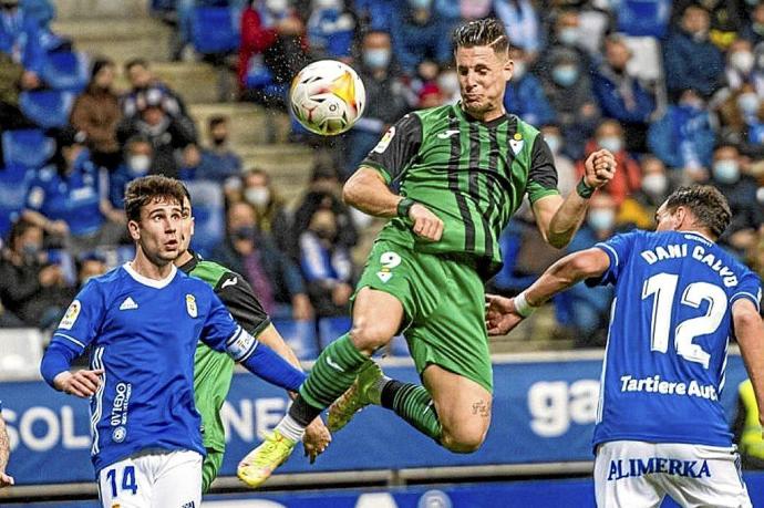 Fran Sol cabecea un balón entre dos jugadores del Oviedo, ayer en el estadio Carlos Tartiere. Foto: LaLiga