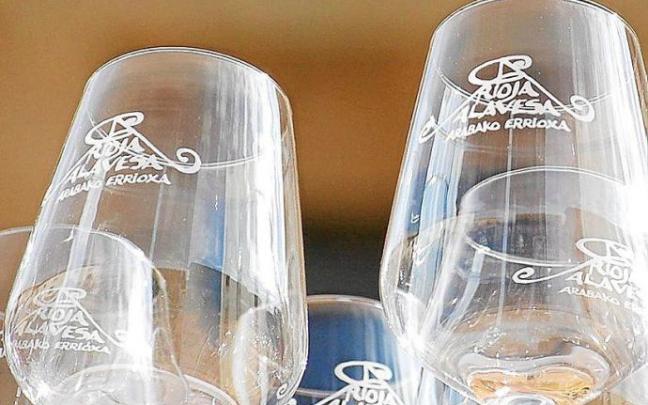 En la imagen de la derecha, una bandeja repleta de copas de vino, con el anagrama serigrafiado de la marca 'Rioja Alavesa'. La Ruta del Vino de esta comarca es una de las más activas en el Estado y una de las mejor posicionadas a la hora de atraer nuevos