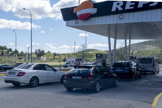 Varios coches repostan en una gasolinera, el día en que entró en vigor la rebaja de 20 céntimos en el litro de la gasolina.