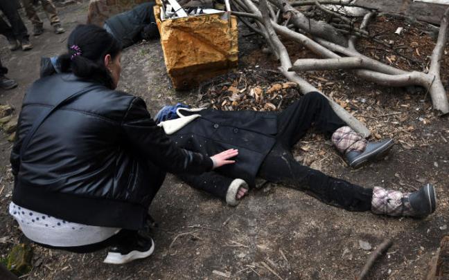 Irina vela los cuerpos de su marido y su hermana en el jardín de una casa en Bucha, 4 de abril. Irina vela los cuerpos de su marido y su hermana en el jardín de una casa en Bucha, 4 de abril.