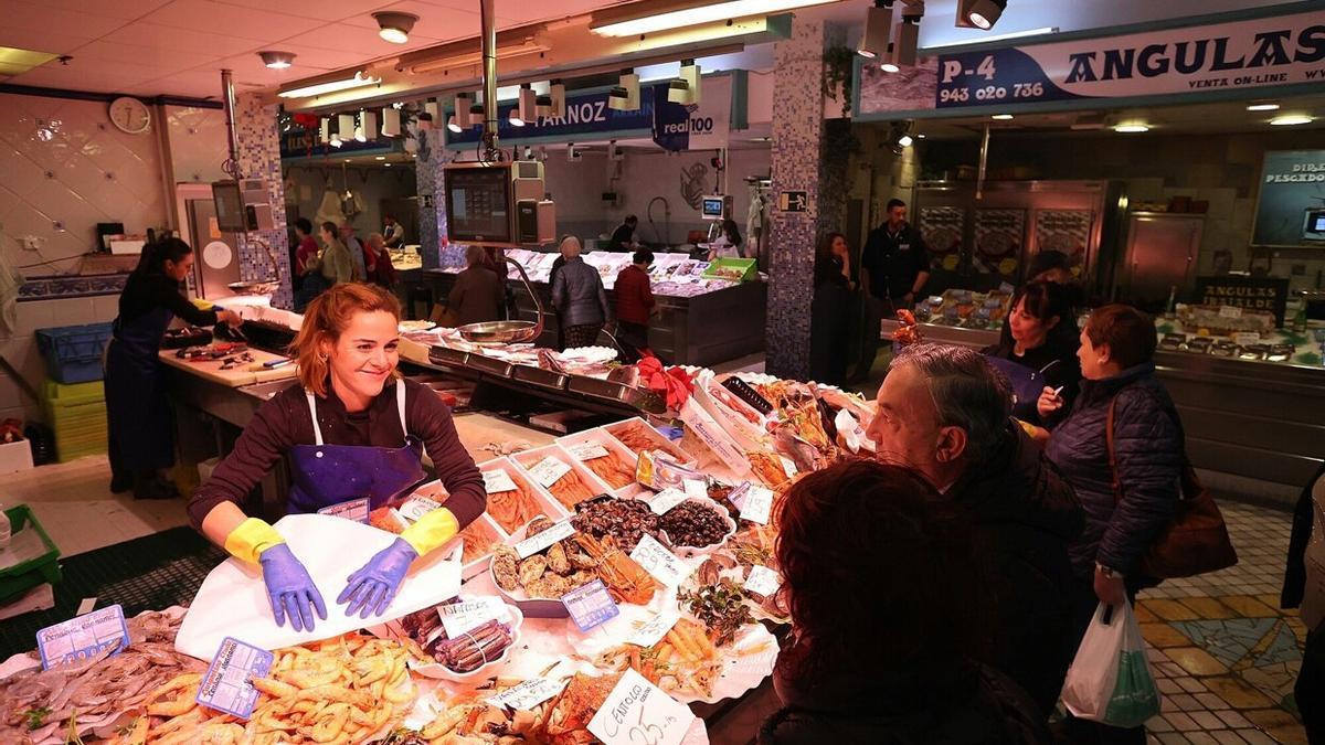 Clientes en una pescadería del mercado de La Bretxa, en Donostia.