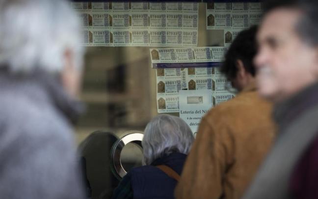 Varias personas hacen cola para comprar lotería para el Sorteo Extraordinario del Niño.