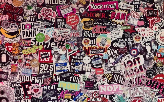 Decenas de pegatinas pegadas en una pared.