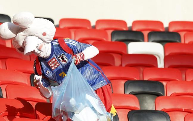 Un aficionado japonés recoge la grada tras el partido. Un aficionado japonés recoge la grada tras el partido.