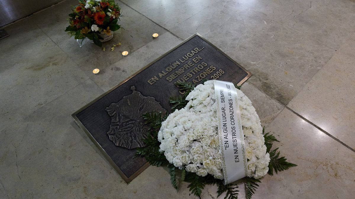 Flores y velas en una placa de bronce en homenaje a las víctimas del accidente de Spanair.