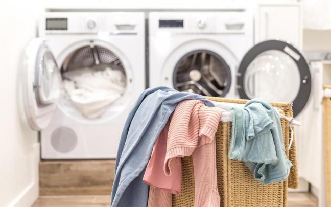 Cesto con ropa sucia que va a ser introducida en la lavadora.