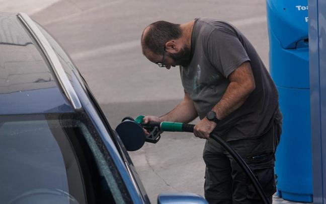Un hombre reposta en una gasolinera.