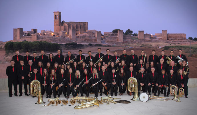 Los 63 integrantes de la Banda de Música de Artajona posan tras el concierto del pasado 3 de septiembre. Al fondo, el majestuoso cerco de la localidad navarra.