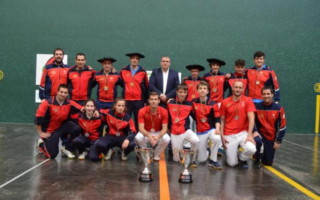 Varios pelotaris de la selección navarra posan con los dos trofeos en el frontón Ogueta de Vitoria.