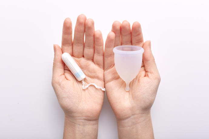 Imagen de una copa menstrual y un tampón.