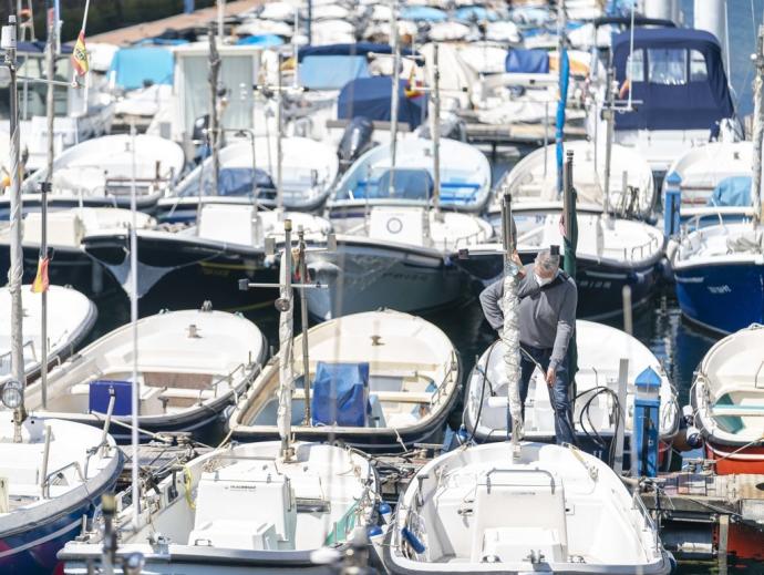 Un hombre en una txipironera en el muelle de Donostia.