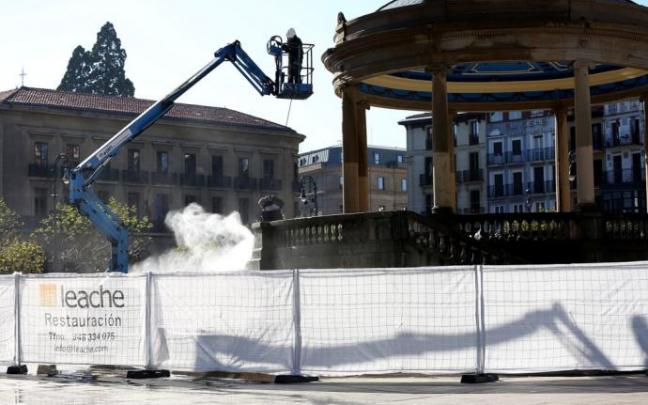 Dos operarios realizan labores de restauración en el kiosco a mediados de noviembre.