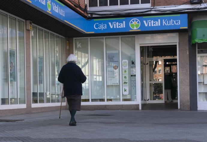 Una mujer se dirige a la oficina de Kutxabank en Reyes de Navarra