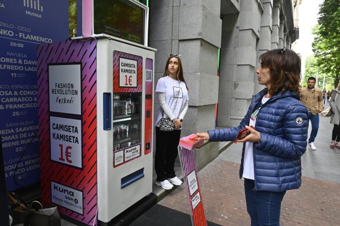 Una mujer utiliza la máquina expendedora que se ubicaba en la sala BBK en la Gran Vía de Bilbao.