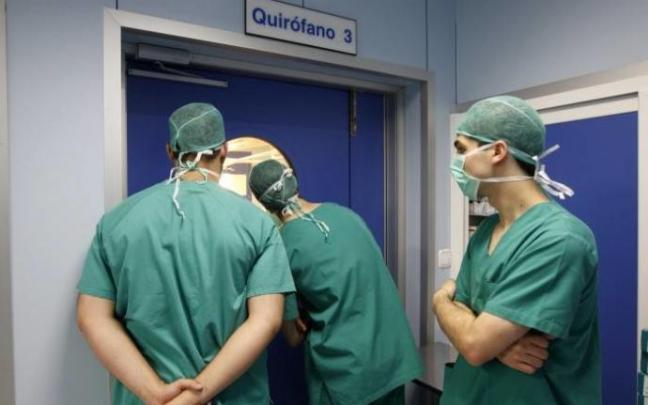 Tres médicos de Osakidetza, frente a un quirófano.