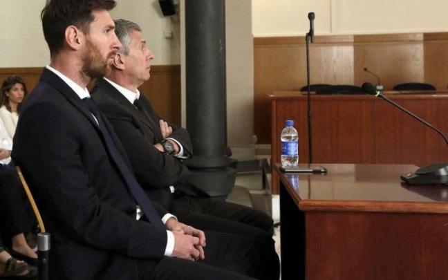 Fotografía de archivo del jugador del FC Barcelona, Lionel Messi y su padre en los juzgados.