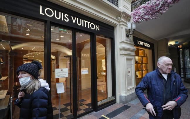 Ciudadanos rusos pasan frente a una tienda cerrada de Louis Vuitton en Moscú. Ciudadanos rusos pasan frente a una tienda cerrada de Louis Vuitton en Moscú.