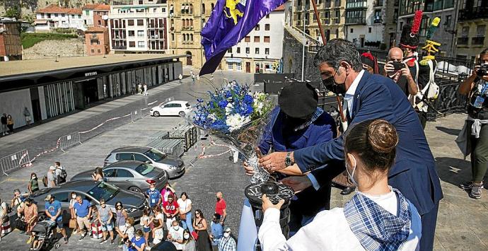 El alcalde y los dantzaris participan en la ofrenda floral, al mediodía de ayer, en Portaletas. Fotos: Iker Azurmendi