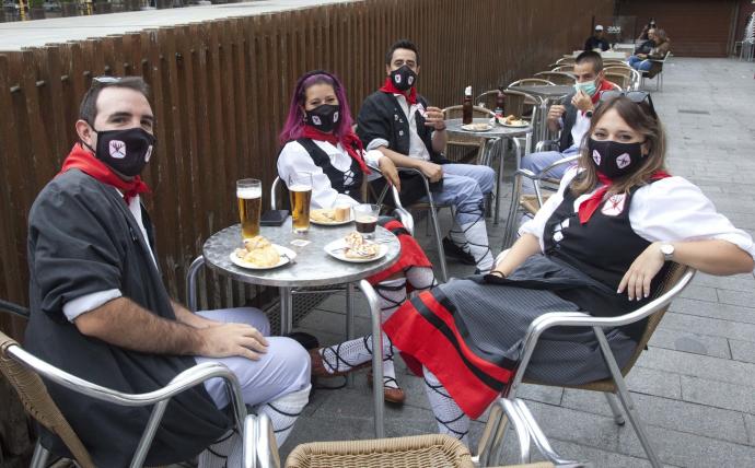 Un grupo de neskas y blusas toman una ronda en un bar de la Virgen Blanca.