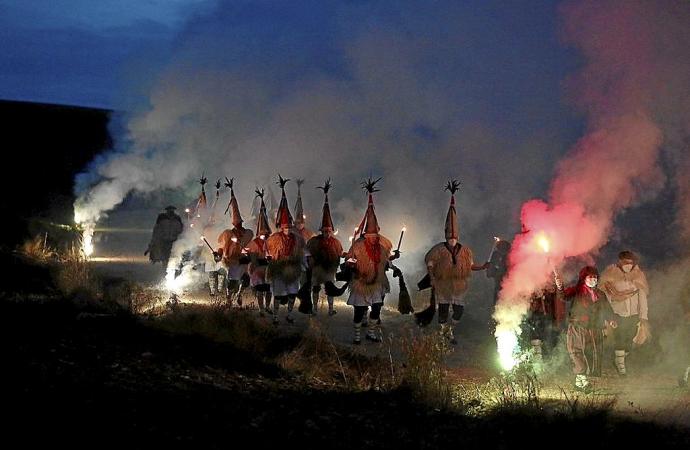 Los joaldunak arropan a Olentzero en su llegada a Sarriguren por el camino de Badostáin.