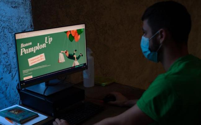 Una persona enseña cómo adquirir los bonos de descuento PamplonUP