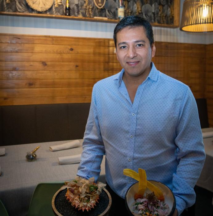 Víctor Lizarbe Garate posa con un plato de soba de chipirones, gambones y katsubuoshi y otro de ceviche de cornina nikkei.