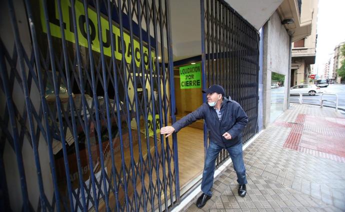 Un comerciante, echando la persiana el año pasado en el II Ensanche.