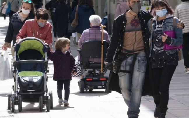 Personas andando con mascarilla por Vitoria.