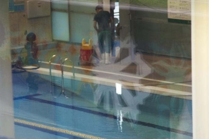 Un operario trabaja en la piscina cubierta del centro civico Aldabe.