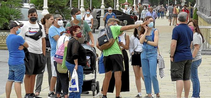 Un guía profesional ofrece explicaciones a un grupo de turistas en Donostia.