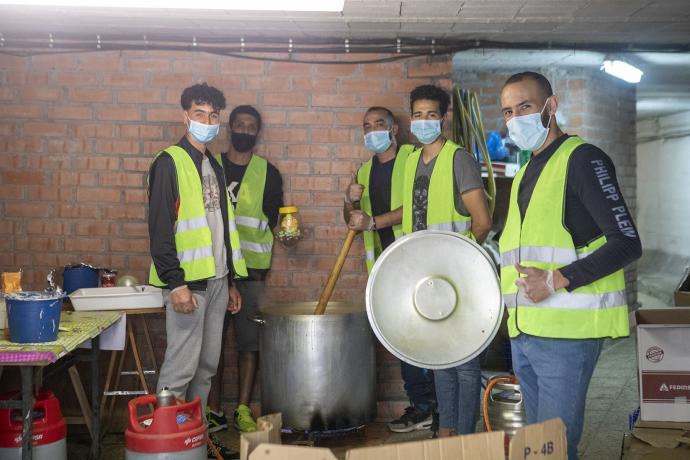 Varios voluntarios musulmanes posan elaborando en un gran puchero la tradicional sopa Harira muy apreciada entre los marroquíes.