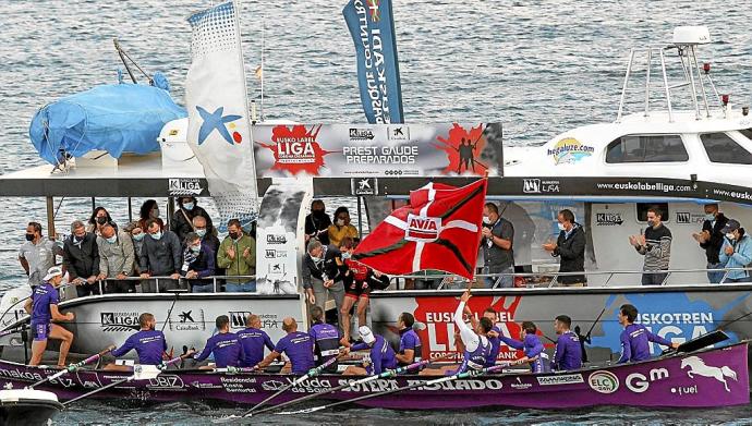 El patrón de la 'Sotera' de Santurtzi, recogiendo el trofeo, la bandera de Bermeo. Foto: Efe