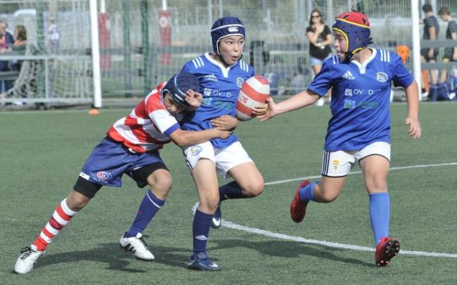 Varios niños juegan a rugby.